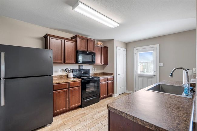 Kitchen with plenty of storage and black appliances | Image 11