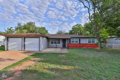 Single story home featuring a front yard and a 2 car garage | Image 1