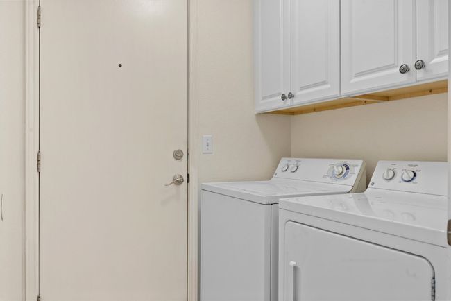 Laundry room featuring washing machine and dryer and cabinet space | Image 10