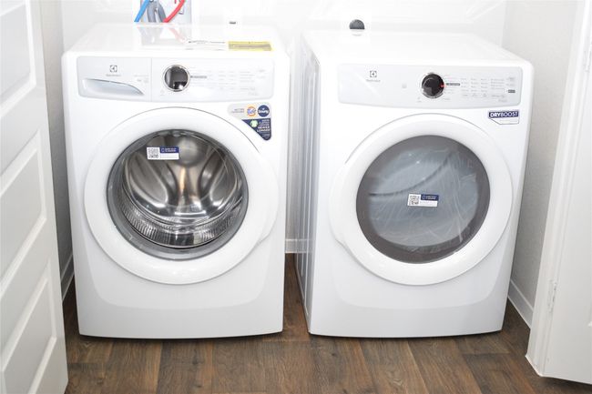 Laundry area with washing machine and clothes dryer and dark wood finished floors | Image 20