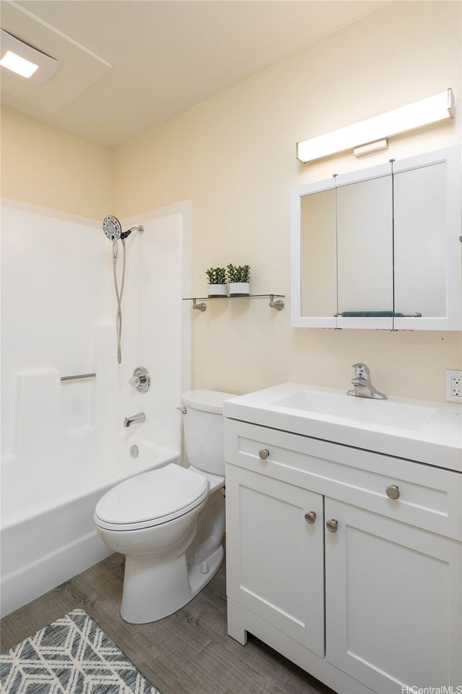 So nice to have fresh paint, new vinyl flooring, vanity, mirror, toilet, fan and fresh tub/surround paint and new showerhead and fixtures. | Image 10