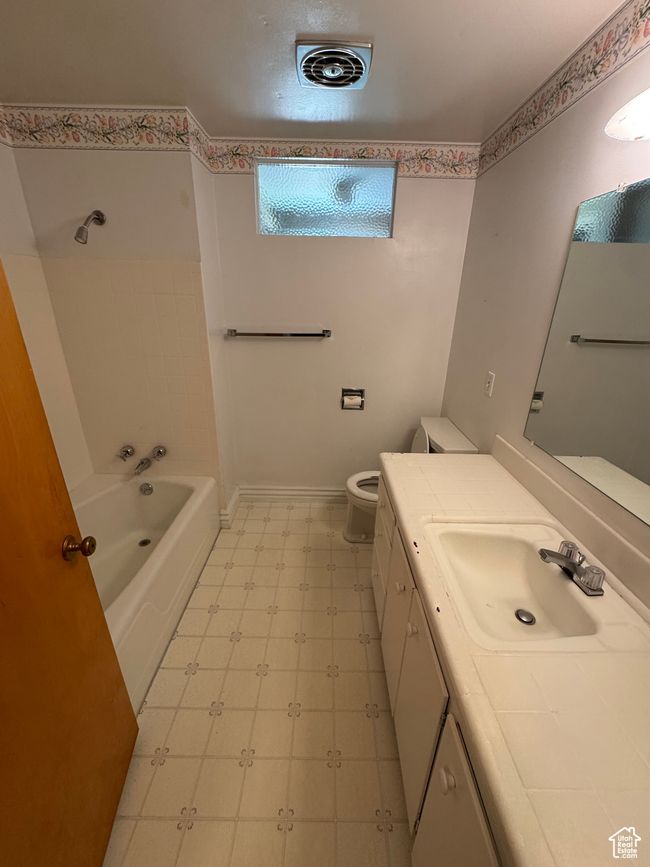 Bathroom with tile patterned floors, vanity, and shower / washtub combination | Image 8