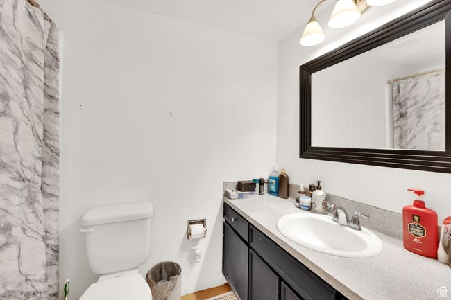 Bathroom featuring vanity and a shower with curtain | Image 5