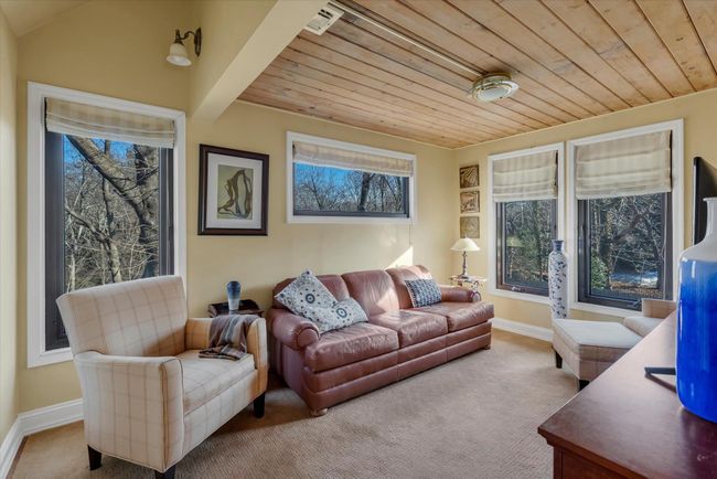 Living room with light carpet and wooden ceiling | Image 16