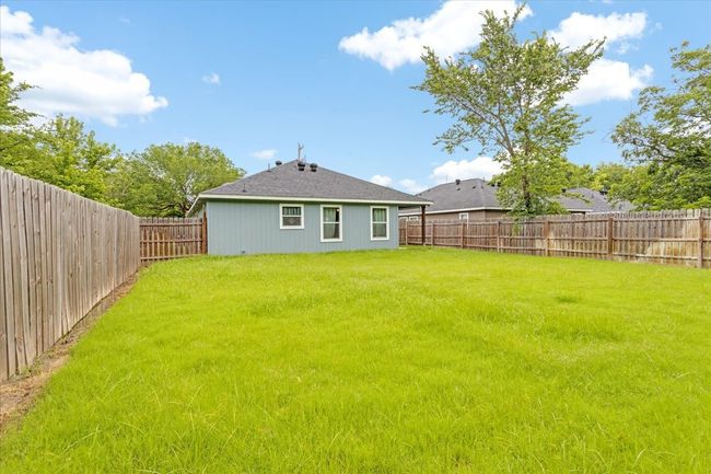 View of fenced backyard | Image 19