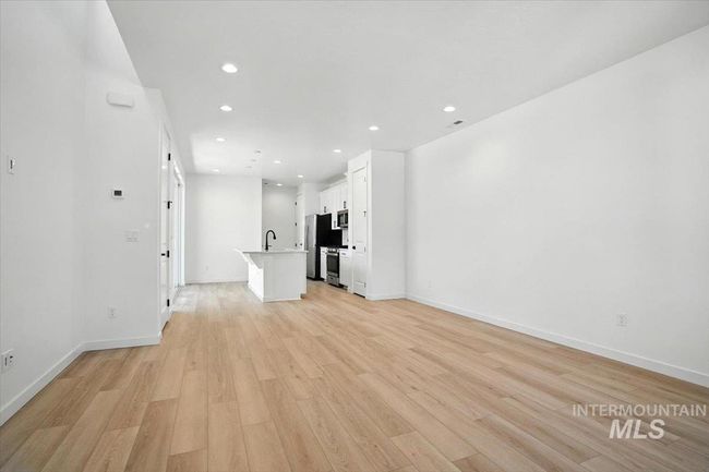 Unfurnished living room featuring light wood-type flooring and recessed lighting | Image 4