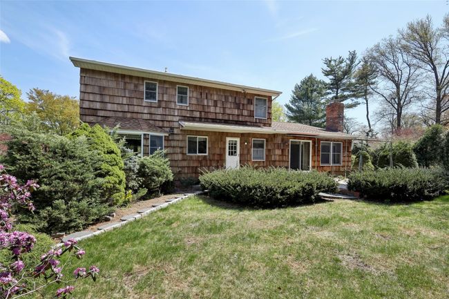 Back of property featuring a chimney and a yard | Image 38