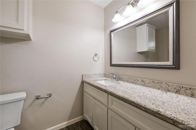 Half bath with vanity and wood finished floors | Image 10