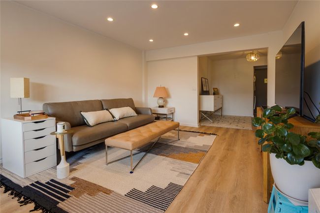 Living room featuring light wood-style flooring and recessed lighting | Image 12
