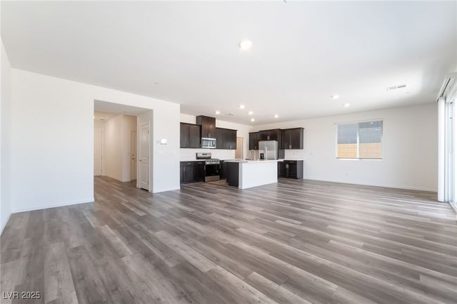 Unfurnished living room featuring light wood-style floors and recessed lighting | Image 6