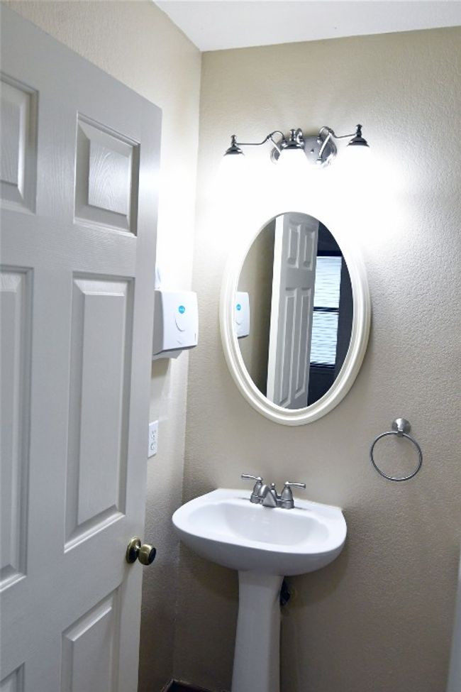 Bathroom featuring a textured wall | Image 6