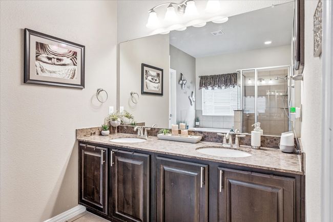 Full bathroom featuring a shower stall, double vanity, and a bathtub | Image 15