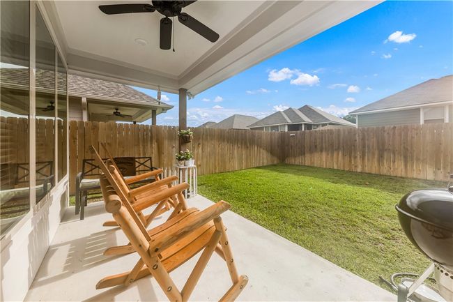 Fenced backyard with ceiling fan | Image 14