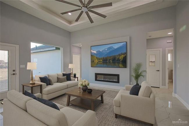 Living room with ceiling fan, a glass covered fireplace, a towering ceiling, recessed lighting, and light marble finish floors | Image 27