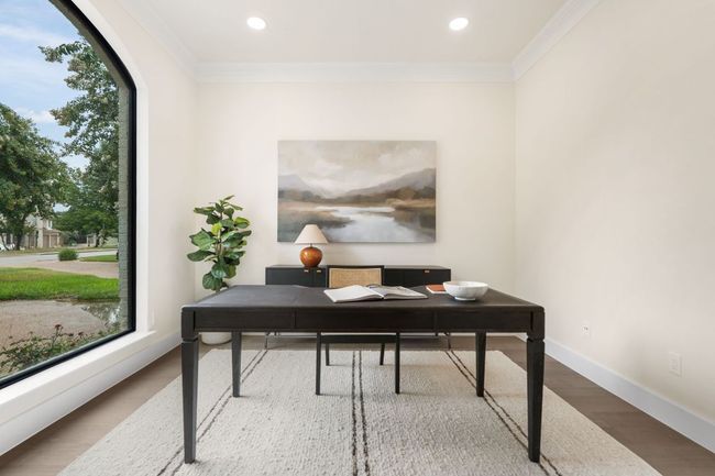 The dedicated home office offers the perfect work-from-home setup, with French doors providing privacy without sacrificing natural light. | Image 14