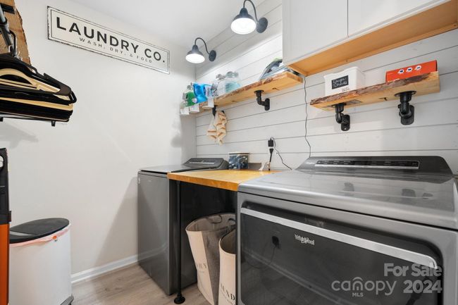 Great laundry room features LVP flooring, ship-lap wall and storage. Washer & Dryer do not convey. | Image 24