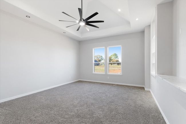 Carpeted spare room with a tray ceiling, ceiling fan, and recessed lighting | Image 19