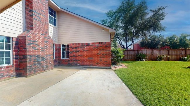 Charming back patio with a view of the private, fenced yard. | Image 42