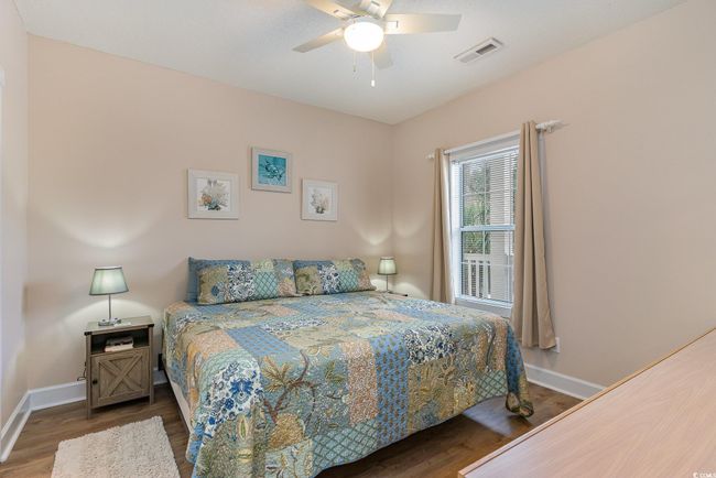 Bedroom featuring ceiling fan and dark hardwood / wood-style flooring | Image 13