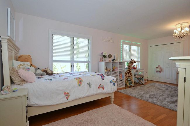 Bedroom featuring an inviting chandelier and light wood-type flooring | Image 15