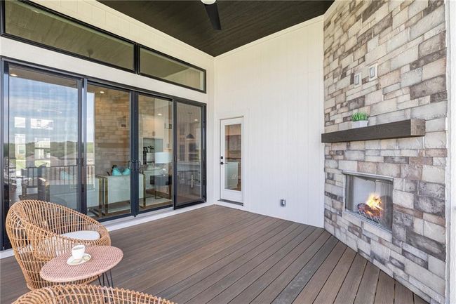 Wooden deck featuring a fireplace and a ceiling fan | Image 35