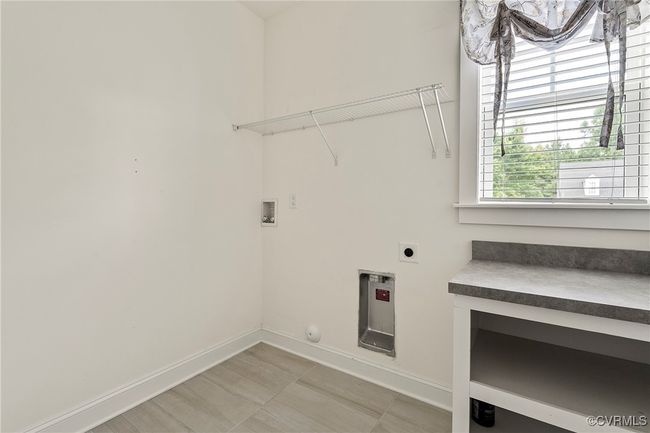 Laundry room featuring electric dryer hookup and hookup for a washing machine | Image 18