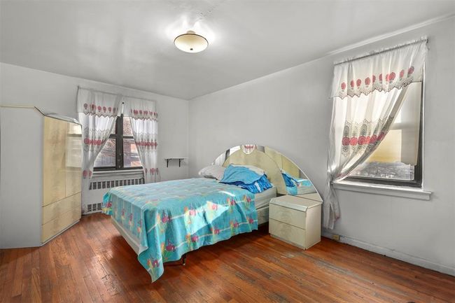 Bedroom with radiator and wood-type flooring | Image 7