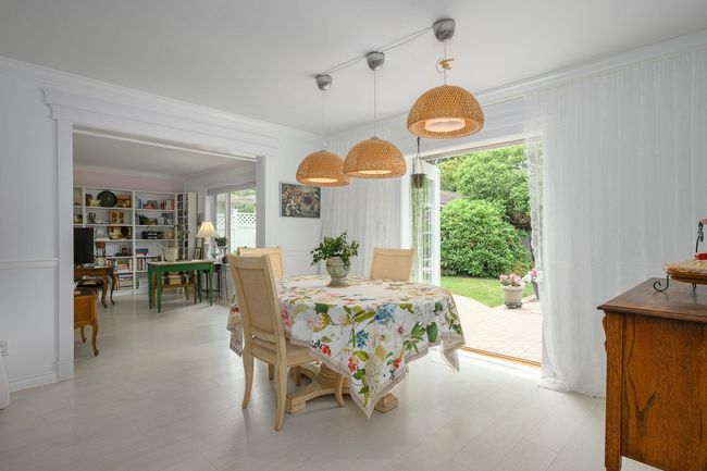 Dining area featuring ornamental molding and light wood-style flooring | Image 7