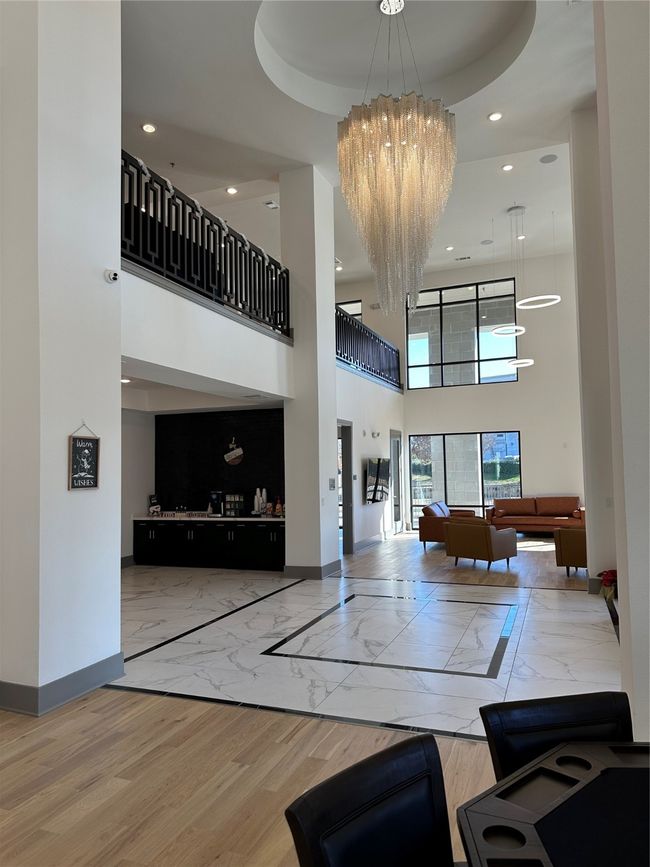 Community lobby with a towering ceiling and recessed lighting | Image 17