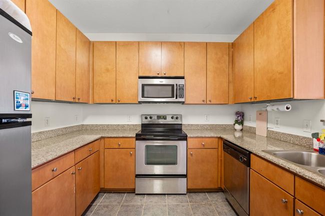 Kitchen featuring appliances with stainless steel finishes and a sink | Image 7