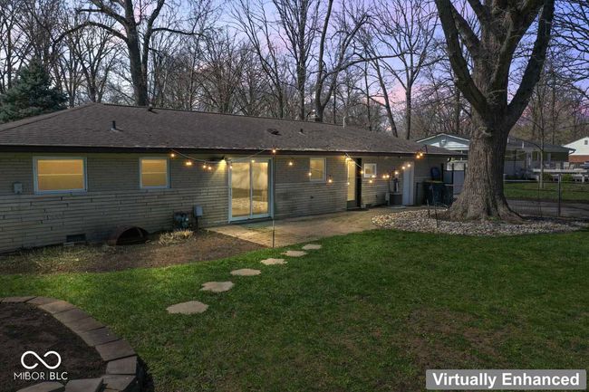 rear view of house with a yard, a shingled roof, brick siding, and a patio | Image 29