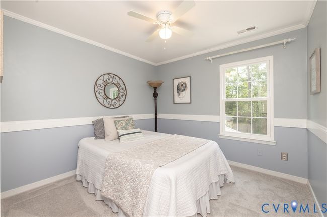 Carpeted bedroom with crown molding and ceiling fan | Image 26
