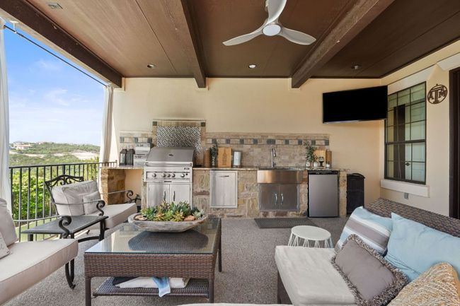 View of patio / terrace featuring a ceiling fan, a sink, area for grilling, an outdoor hangout area, and grilling area | Image 26
