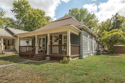 View of front of property featuring cooling unit, a porch, and a front yard | Image 2