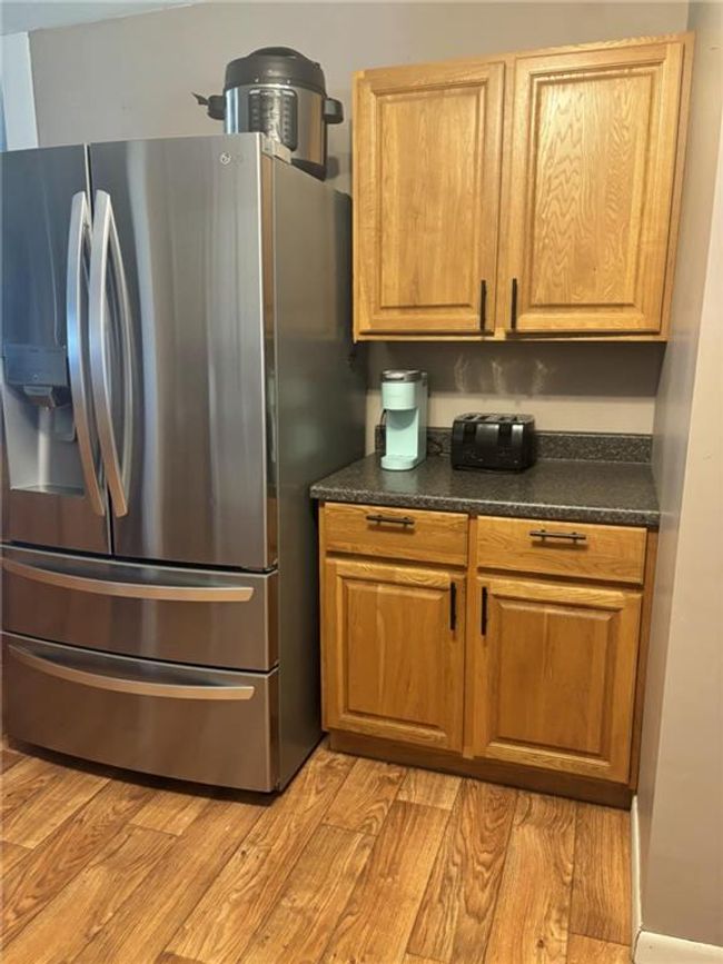 Kitchen featuring stainless steel fridge and laminate flooring | Image 9