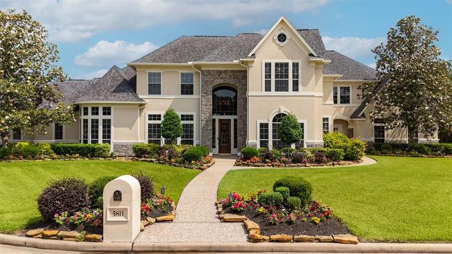 The home's stunning facade combines timeless architecture with thoughtful modern updates, including a beautiful stone enhancement completed in 2021. Behind the beauty, key systems have been meticulously maintained: a new A/C installed in 2019, the roof professionally conditioned in 2023, and a full-home generator added in 2024 for peace of mind. The fence was also replaced in 2021, ensuring the exterior is as functional as it is beautiful. | Image 5