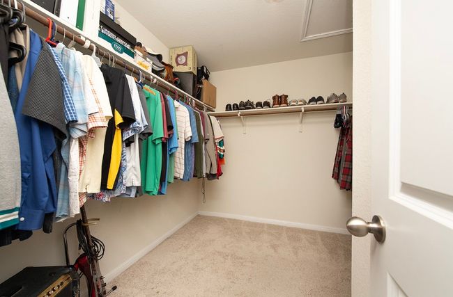Spacious closet featuring carpet flooring and attic access | Image 16