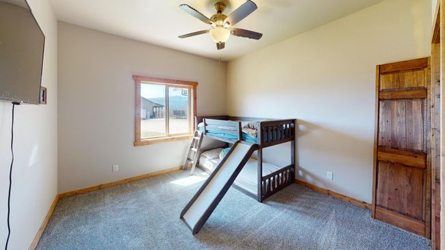 Bedroom featuring ceiling fan, carpet flooring, and baseboards | Image 14