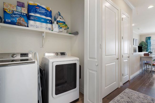 2nd Floor Laundry room with laundry area, ornamental molding, washer/dryer, and wood finished floors | Image 26