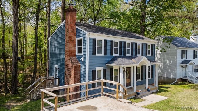 Colonial home with a chimney and a front yard | Image 33