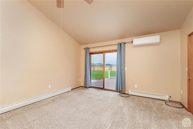Master bedroom with vaulted ceiling and patio doors to west facing back deck. | Image 11