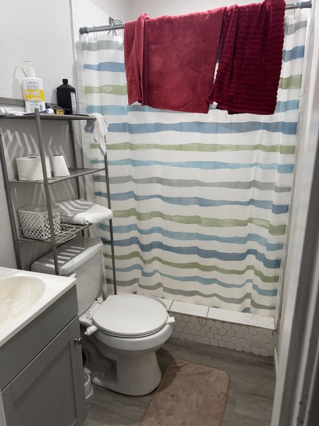 Bathroom featuring wood finished floors, vanity, and a shower with curtain | Image 14