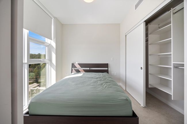 Carpeted bedroom with baseboards, visible vents, and a closet | Image 12