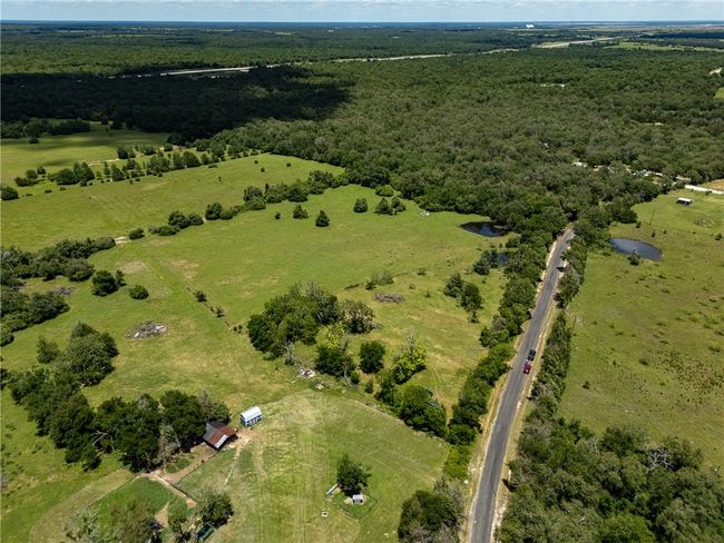 Aerial overview of property's location featuring a forest and rural landscape | Image 12