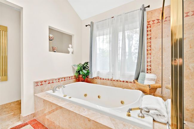 Bathroom with lofted ceiling and a whirlpool tub | Image 30