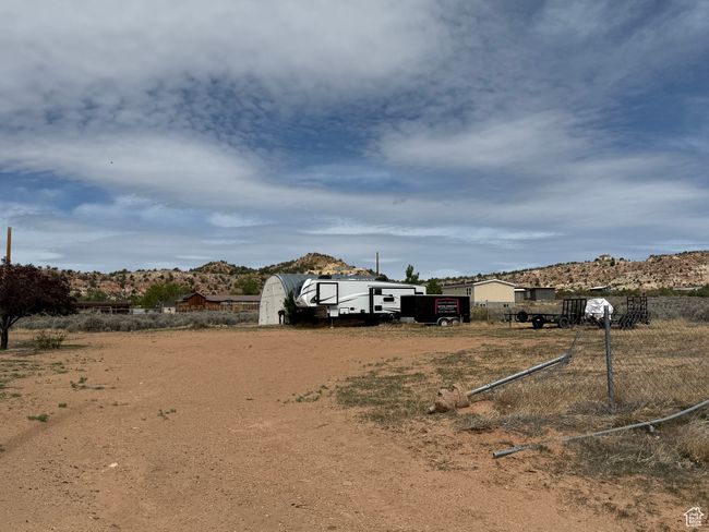View of yard featuring an outbuilding and a storage shed | Image 24