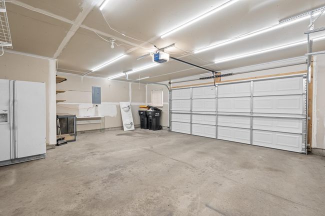 Oversized 2 car garage with additional storage space to sides of garage. | Image 36