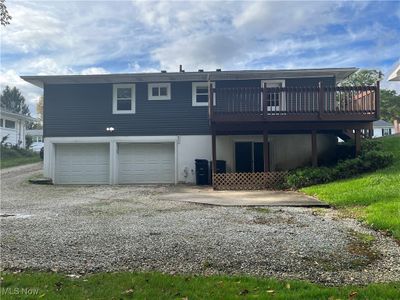 Back of house featuring a garage and a deck | Image 3