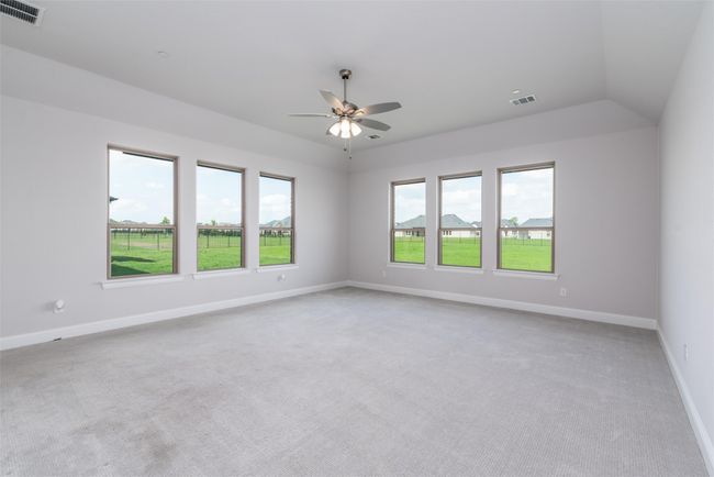 Empty room featuring light carpet, a ceiling fan, and baseboards | Image 26