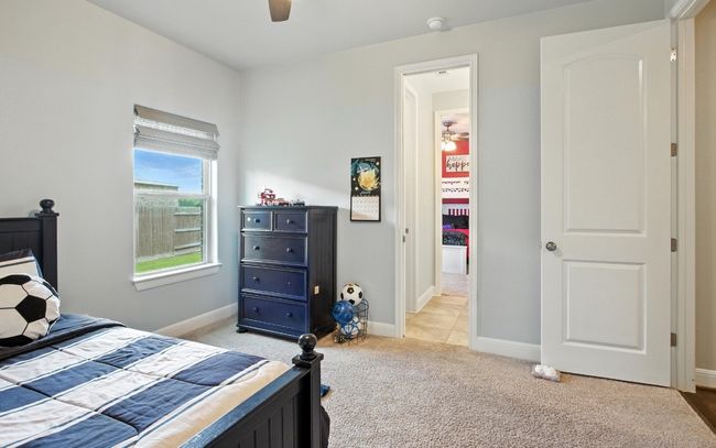 Bedroom with light colored carpet and a ceiling fan | Image 23